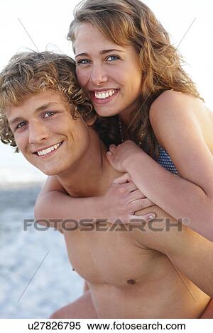 Young man carrying girlfriend on back View Large Photo Image Stock Photography - Young man carrying girlfriend on back. Fotosearch