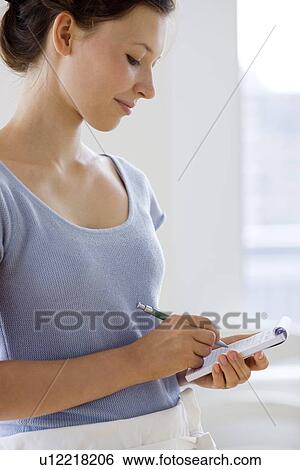Stock Photograph - Young waitress taking order. Fotosearch