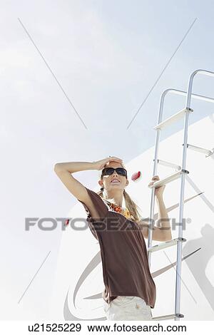 Young woman climbing motor home ladder View Large Photo Image Stock Photo - Young woman climbing motor home ladder. Fotosearch