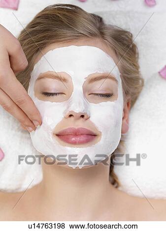 Stock Photo - Young woman getting facial spa treatment. Fotosearch