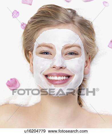 Stock Photo - Young woman getting facial spa treatment. Fotosearch