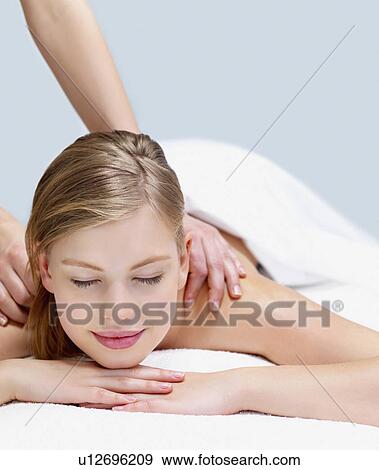 Young woman getting massage View Large Photo Image Stock Photo - Young woman getting massage. Fotosearch