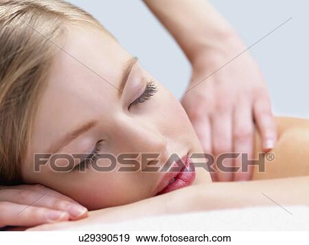 Stock Photo - Young woman getting massage. Fotosearch