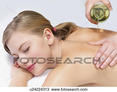 Young woman getting oil massage View Large Photo Image Stock Image - Young woman getting oil massage. Fotosearch