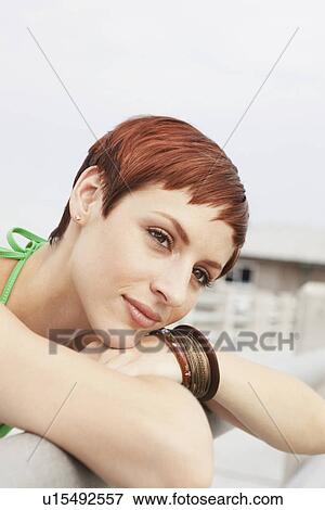 Young woman leaning on boardwalk railing View Large Photo Image Stock Photo - Young woman leaning on boardwalk railing. Fotosearch