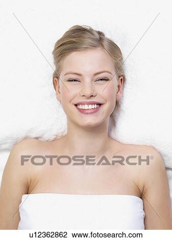 Young woman lying down in massage table View Large Photo Image Stock Image - Young woman lying down in massage table. Fotosearch