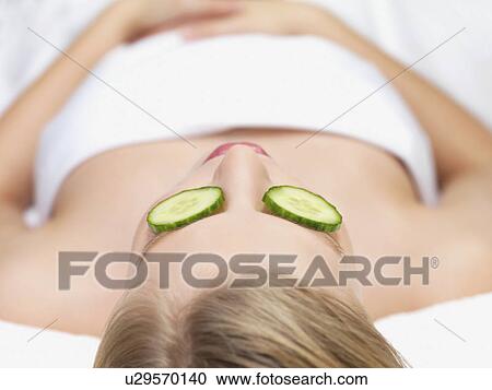 Young woman lying down in massage table View Large Photo Image Stock Image - Young woman lying down in massage table. Fotosearch
