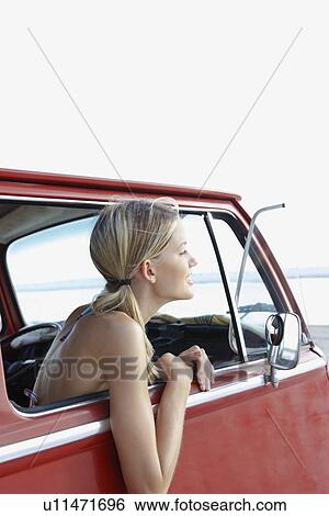 Young woman sitting in van on beach View Large Photo Image Stock Photograph - Young woman sitting in van on beach. Fotosearch