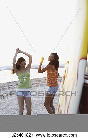 Young women dancing on beach View Large Photo Image Stock Photo - Young women dancing on beach. Fotosearch