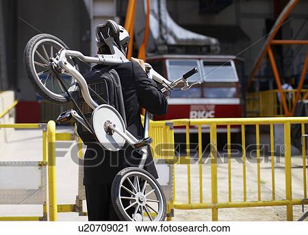 Businessman Carrying Bicycle to Roosevelt Island Tramway View Large Photo Image Stock Image - Businessman Carrying Bicycle to Roosevelt Island Tramway. Fotosearch