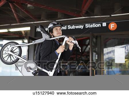 Businessman Carrying Bicycle to Subway Station View Large Photo Image Stock Image - Businessman Carrying Bicycle to Subway Station. Fotosearch