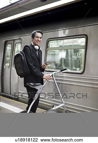 Stock Image - Businessman Commuting by Bicycle and Subway. Fotosearch