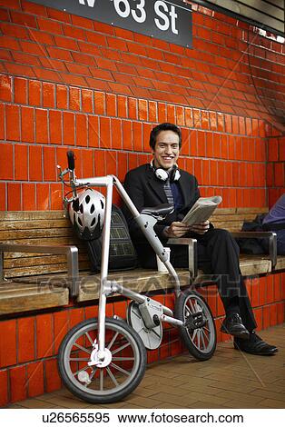 Stock Photography - Businessman Commuting by Bike and Subway. Fotosearch