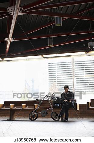 Businessman Making Notes at Subway Station View Large Photo Image Stock Photo - Businessman Making Notes at Subway Station. Fotosearch