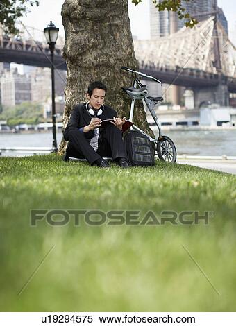 Businessman Making Notes Under Tree View Large Photo Image Stock Photography - Businessman Making Notes Under Tree. Fotosearch