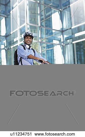 Stock Image - Businessman on Folding Bike. Fotosearch
