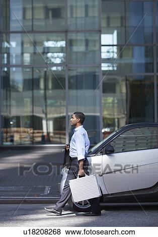 Businessman Walking by Smart Car View Large Photo Image Stock Photo - Businessman Walking by Smart Car . Fotosearch