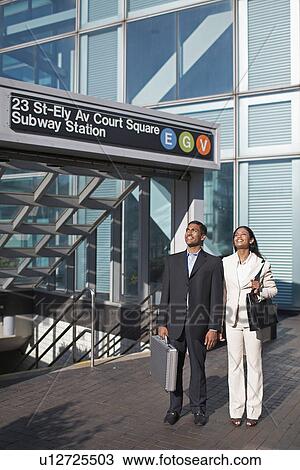 Stock Image - Businesswoman and Businessman at Subway Station. Fotosearch