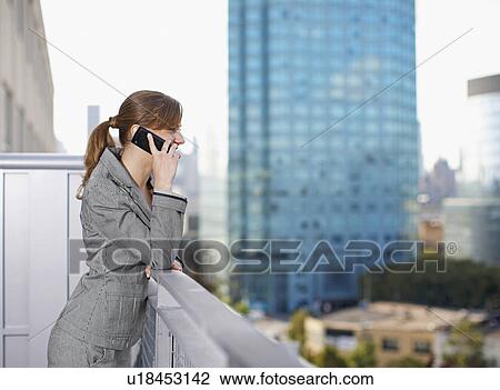 Businesswoman Using Cell Phone on Balcony View Large Photo Image Stock Image - Businesswoman Using Cell Phone on Balcony. Fotosearch