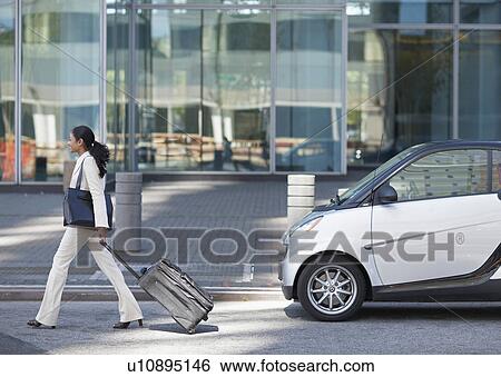 Businesswoman Walking by Smart Car View Large Photo Image Stock Photograph - Businesswoman Walking by Smart Car . Fotosearch
