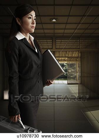 Stock Image - Businesswoman with Briefcase and Folder. Fotosearch
