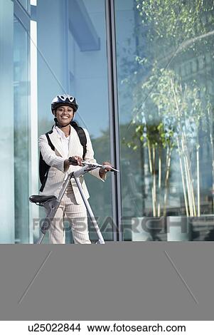 Picture - Businesswoman with Folding Bike. Fotosearch