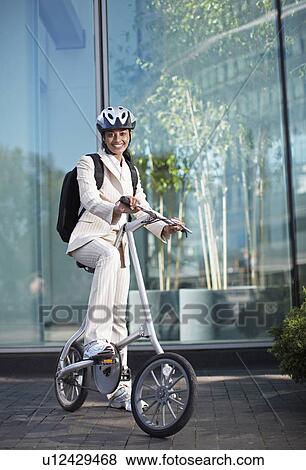 Stock Photo - Businesswoman with Folding Bike. Fotosearch