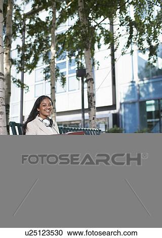 Businesswoman with Notebook on Bench View Large Photo Image Stock Image - Businesswoman with Notebook on Bench. Fotosearch