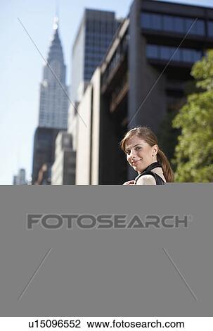 Stock Image - Businesswoman with Solar Panelled Backpack. Fotosearch