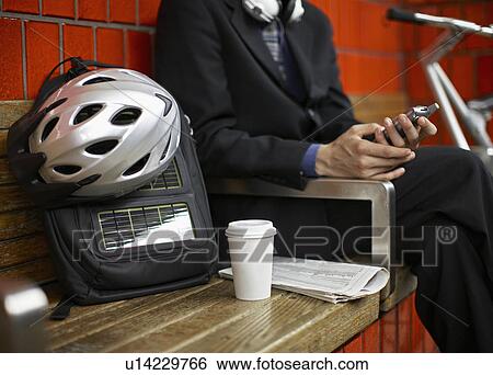 Close-Up of Commuter Sitting on Bench at Subway Station View Large Photo Image Stock Photograph - Close-Up of Commuter Sitting on Bench at Subway Station. Fotosearch