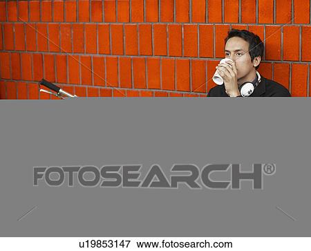 Commuter Drinking Coffee at Subway Station View Large Photo Image Stock Photo - Commuter Drinking Coffee at Subway Station. Fotosearch