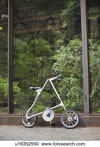 Stock Image - Folding Bicycle by Indoor Garden. Fotosearch