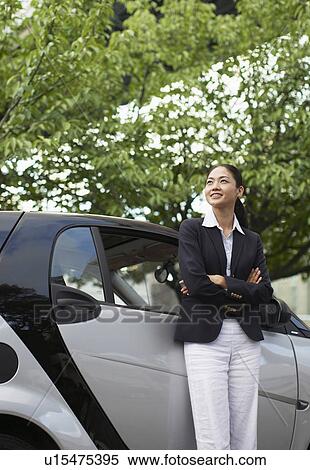 Stock Photography - Happy Woman by Smart Car. Fotosearch