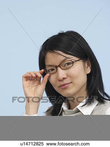 Mid-Adult Businesswoman Adjusting Eyeglasses View Large Photo Image Stock Photography - Mid-Adult Businesswoman Adjusting Eyeglasses. Fotosearch