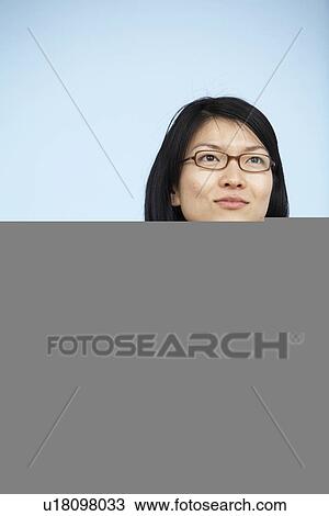 Stock Image - Mid-Adult Businesswoman Holding Alarm Clock. Fotosearch