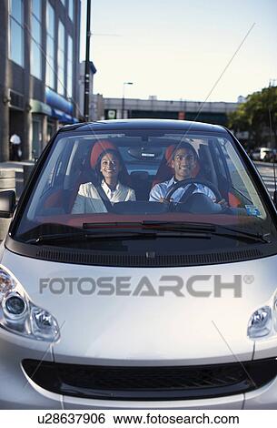 Stock Photograph - Mid-Adult Couple Driving Smart Car. Fotosearch