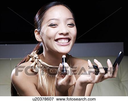 Mid-Adult Woman Applying Lipstick View Large Photo Image Stock Photo - Mid-Adult Woman Applying Lipstick. Fotosearch