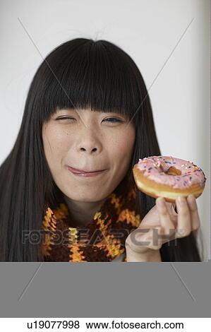 Mid-Adult Woman Eating Donut View Large Photo Image Stock Photo - Mid-Adult Woman Eating Donut. Fotosearch