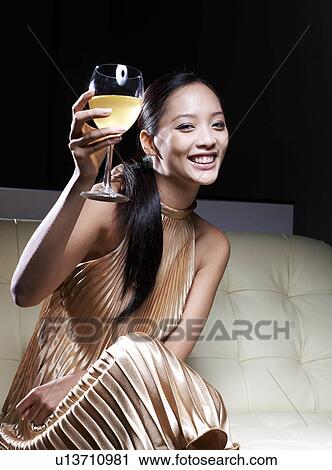 Mid-Adult Woman in Evening Dress Toasting With White Wine View Large Photo Image Stock Image - Mid-Adult Woman in Evening Dress Toasting With White Wine . Fotosearch