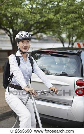 Mid-Adult Woman on Bicycle Beside Smart Car View Large Photo Image Stock Image - Mid-Adult Woman on Bicycle Beside Smart Car. Fotosearch