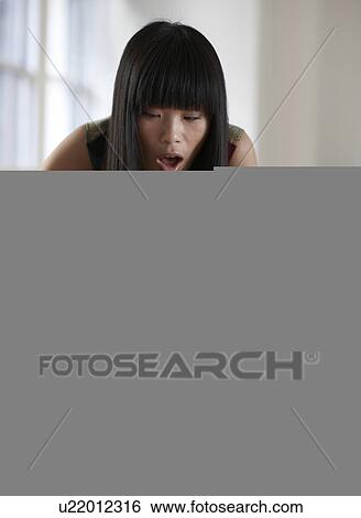 Mid Adult Woman Taking Goods From Shopping Bag View Large Photo Image Stock Photograph - Mid Adult Woman Taking Goods From Shopping Bag . Fotosearch