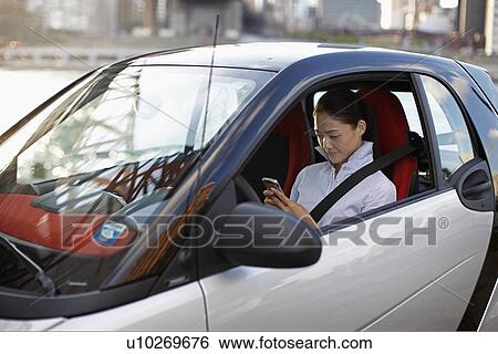 Stock Photograph - Mid-Adult Woman Text Messaging. Fotosearch