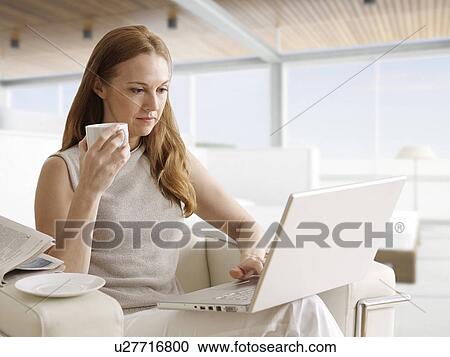 Mid-Adult Woman Using Laptop and Having Coffee View Large Photo Image Stock Image - Mid-Adult Woman Using Laptop and Having Coffee. Fotosearch