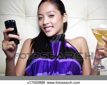 Mid-Adult Woman with Cell Phone Having Cocktail View Large Photo Image Stock Photo - Mid-Adult Woman with Cell Phone Having Cocktail. Fotosearch