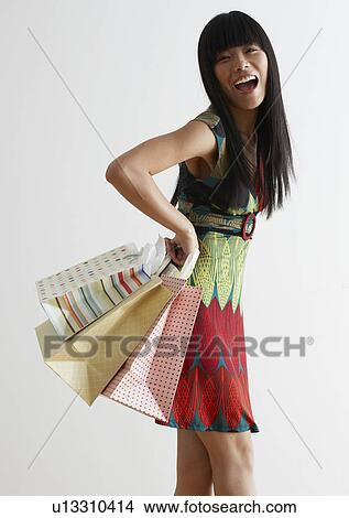Picture - Mid Adult Woman with Shopping Bags. Fotosearch