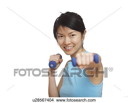 Picture - Mid-Adult Woman Working Out with Dumbbells. Fotosearch