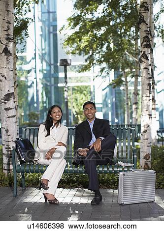 Stock Photo - Portrait of Two Businesspeople on Park Bench. Fotosearch