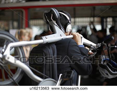 Rear View of Businessman Carrying Bicycle View Large Photo Image Stock Image - Rear View of Businessman Carrying Bicycle. Fotosearch