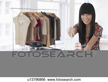 Sales Clerk Giving Shopping Bag View Large Photo Image Stock Photograph - Sales Clerk Giving Shopping Bag. Fotosearch
