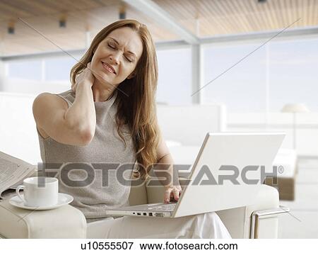 Tired Mid-Adult Woman with Laptop Stretching Neck View Large Photo Image Stock Photo - Tired Mid-Adult Woman with Laptop Stretching Neck. Fotosearch
